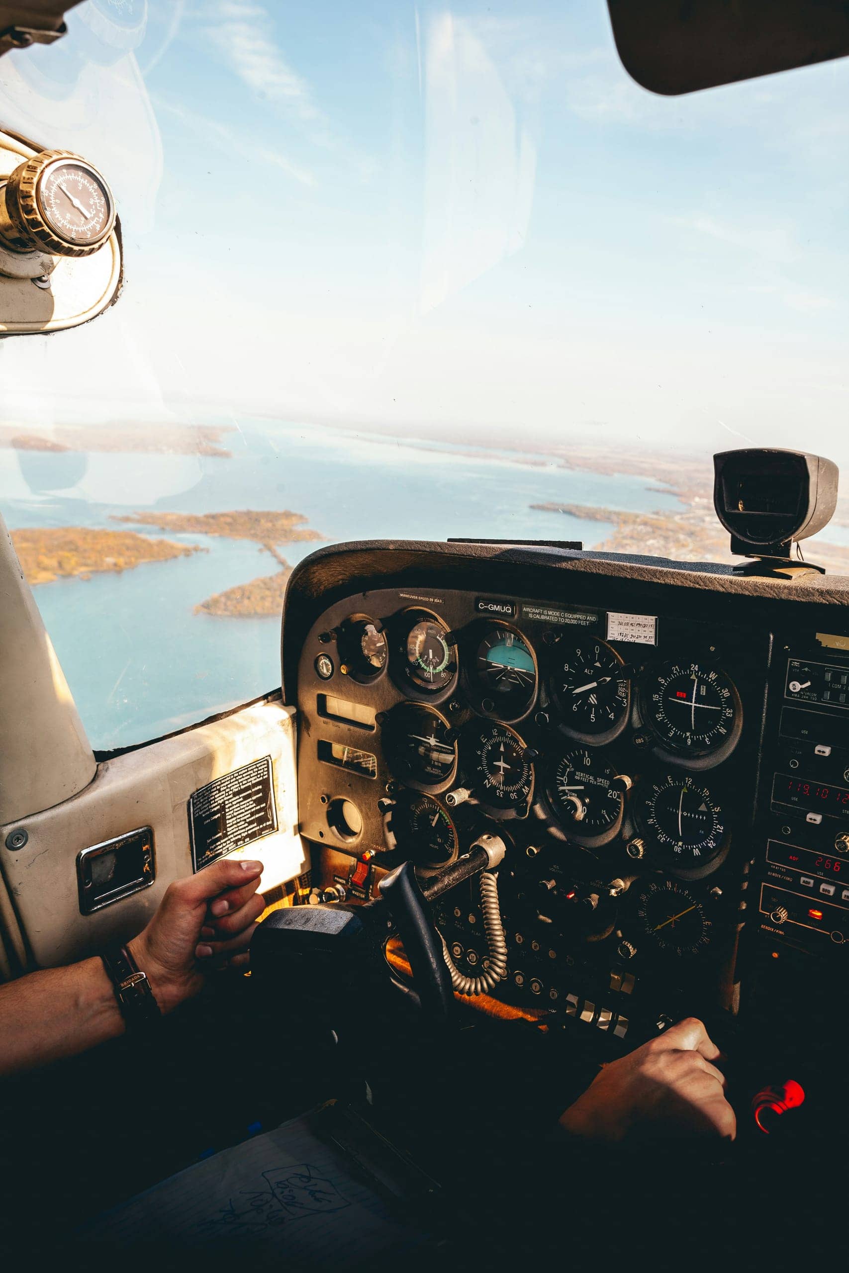 Pilot at the controls of a sightseeing flight over a coastline