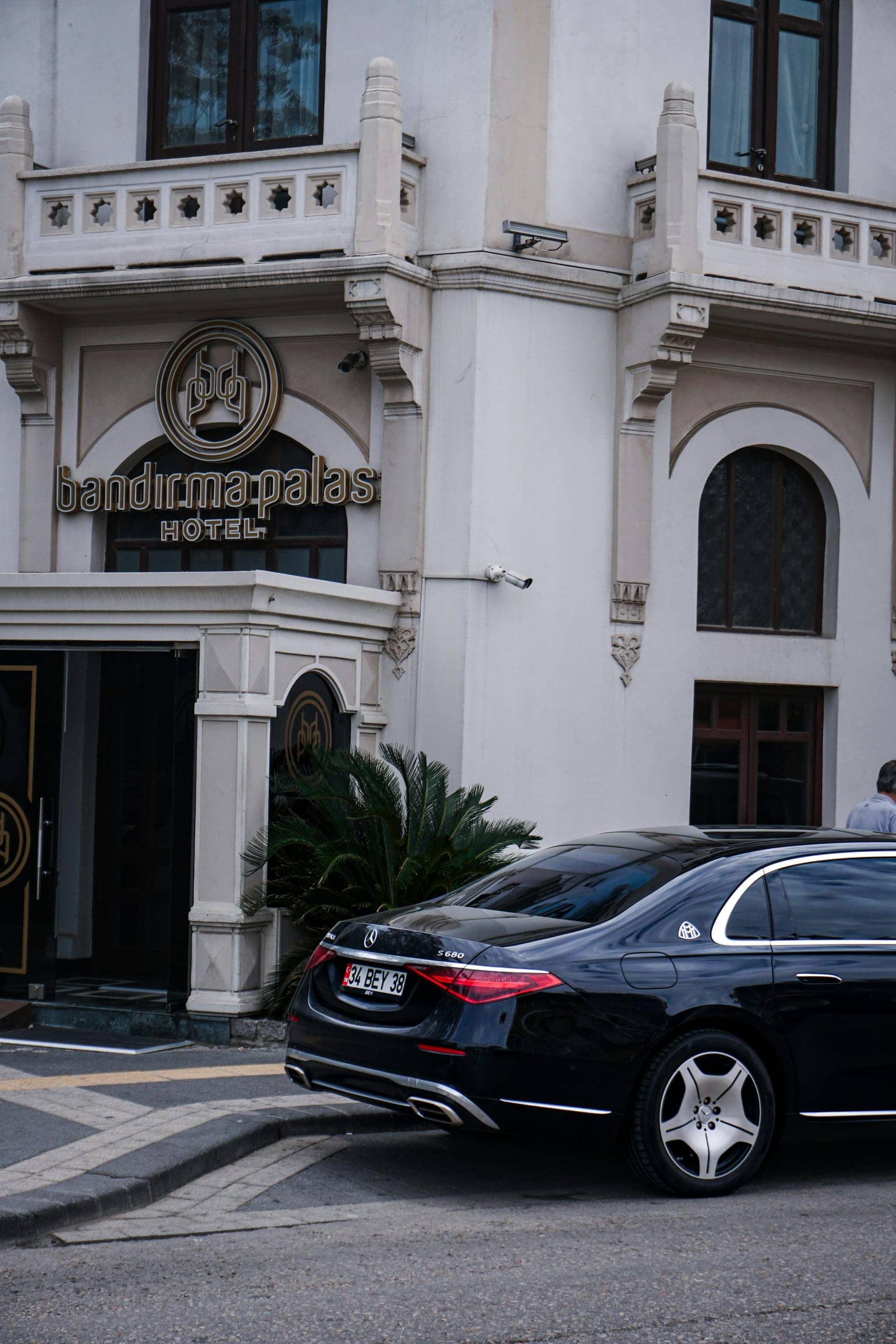 Mercedes S-Class waiting outside a boutique hotel entrance