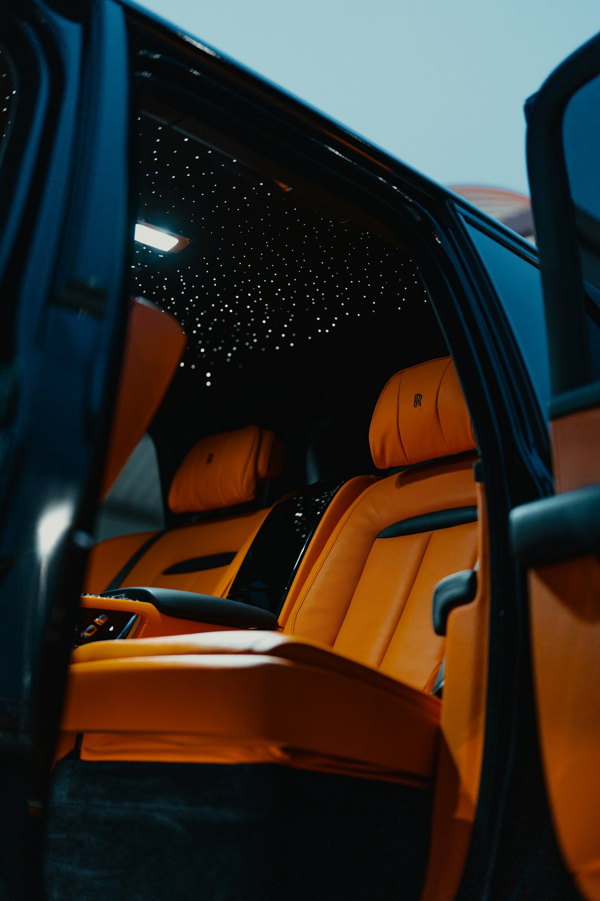 Interno di auto di lusso con porta aperta al tramonto